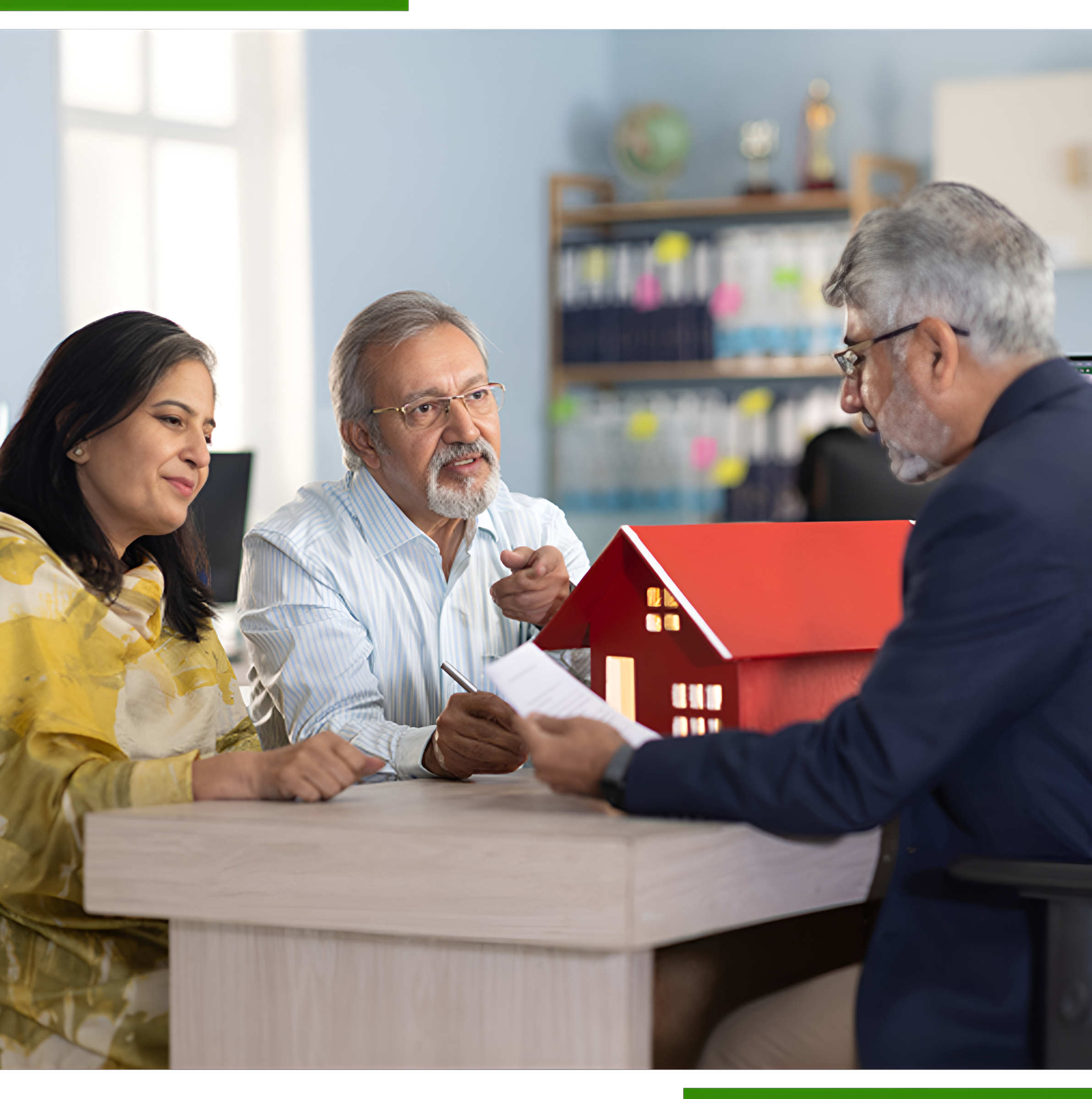 Couple reviewing house documents with agent