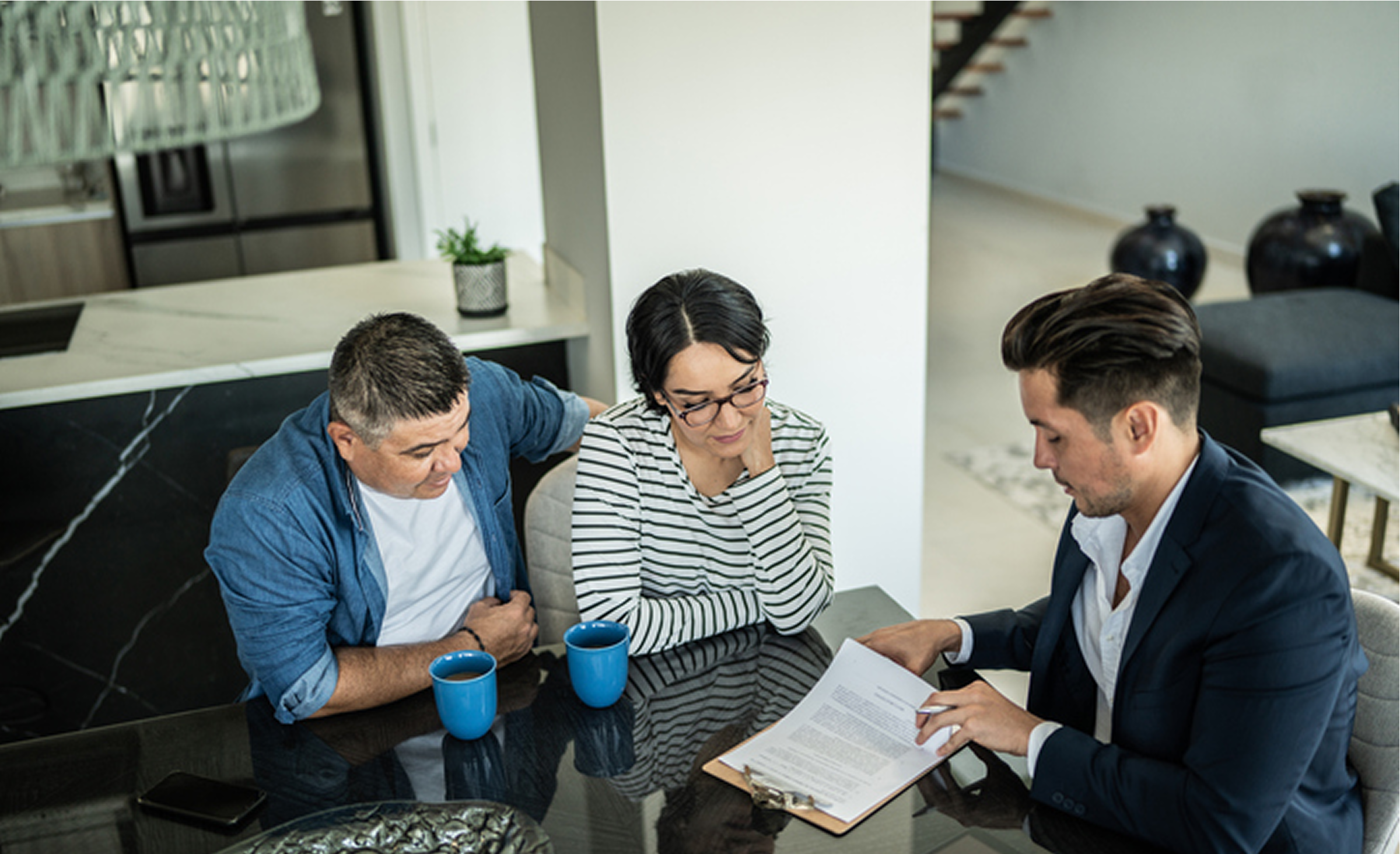 Meeting around kitchen table with paperwork