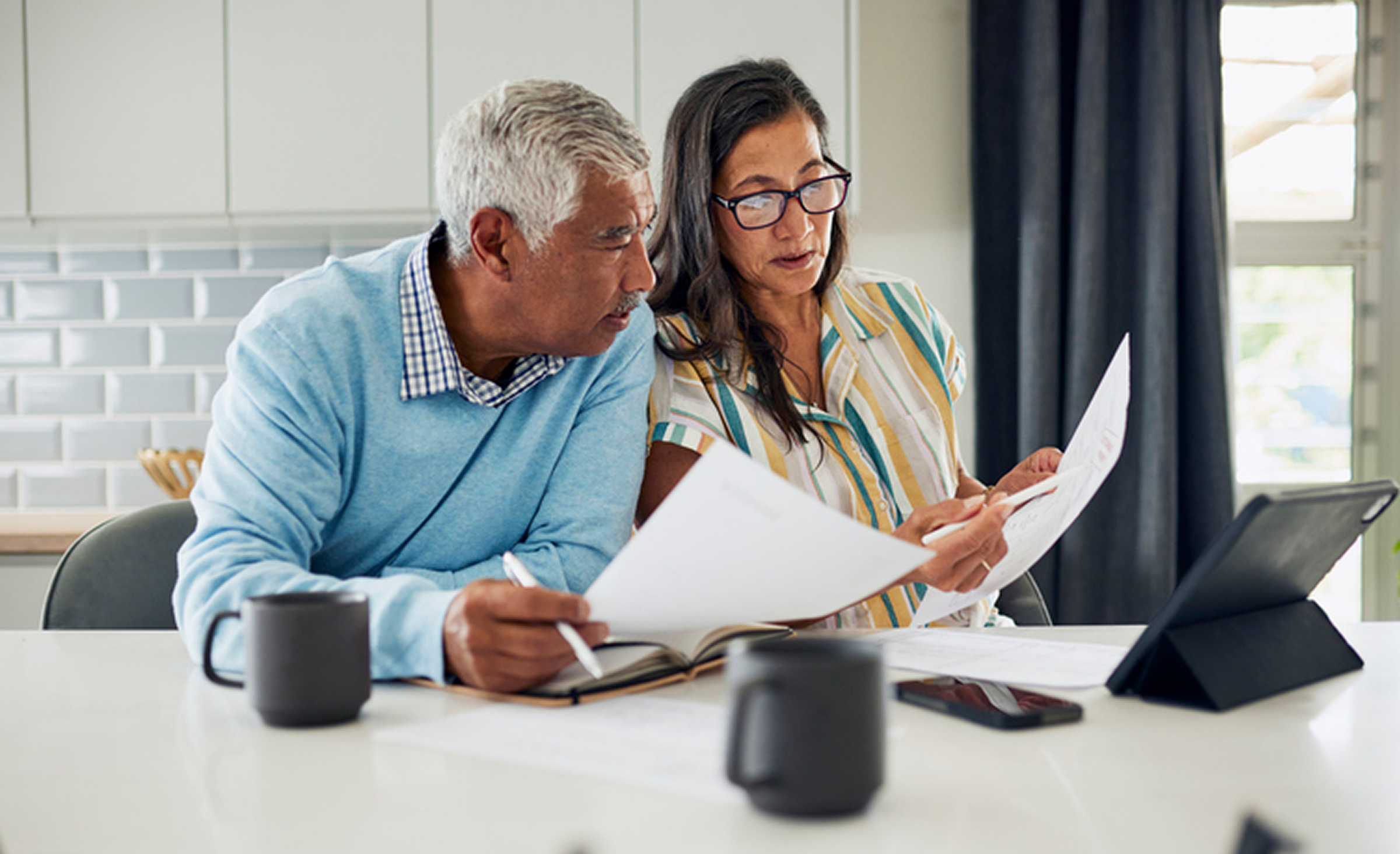 Senior couple analyzing paperwork