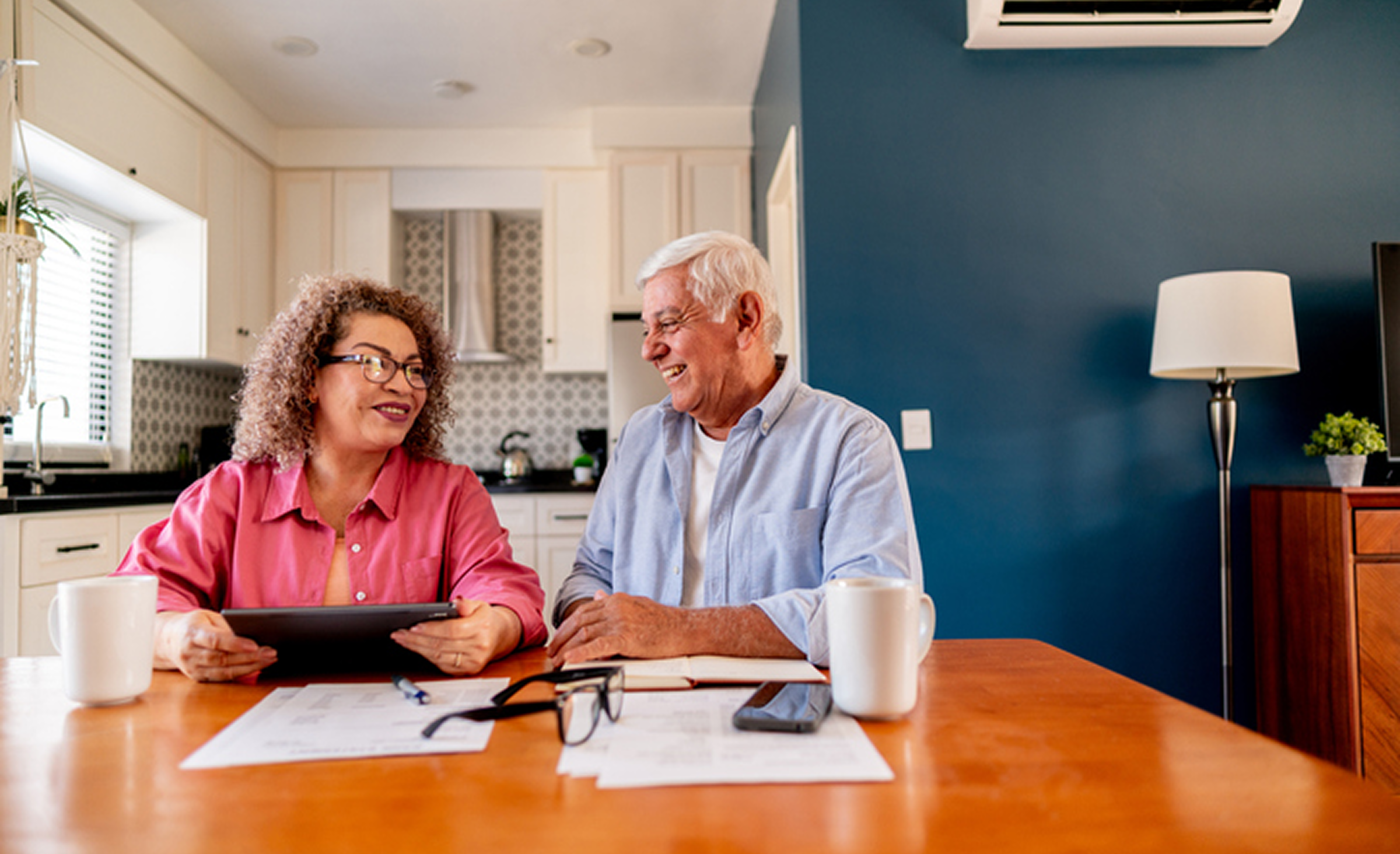 Senior couple smiling over breakfast table